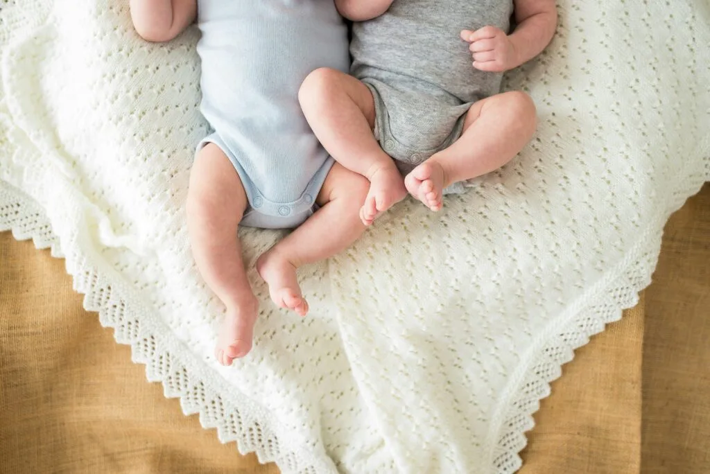 jumeaux allaités allongés sur une couverture